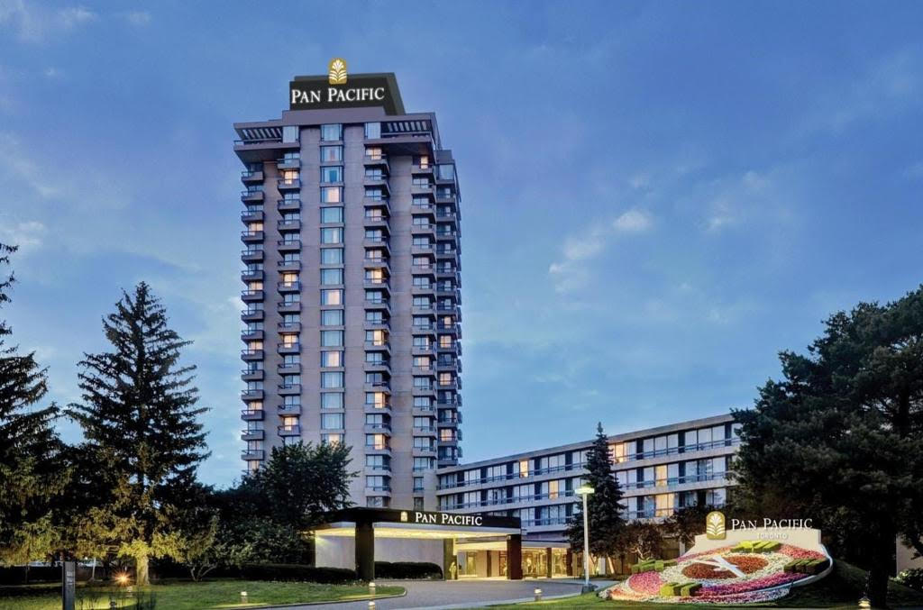 Pan Pacific Toronto hotel exterior with beautiful landscaping and blue sky